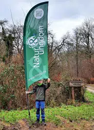 Natur og Ungdom Kolding - en der står med deres flagbanner