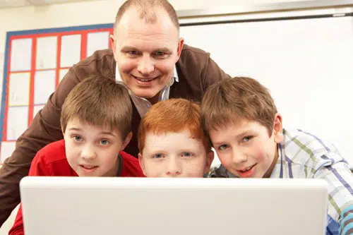 Voksen og tre børn bag computerskærm